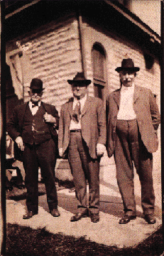 William Smith, Shorty Wible, and Lou Smith, standing behind the Smith factory office
