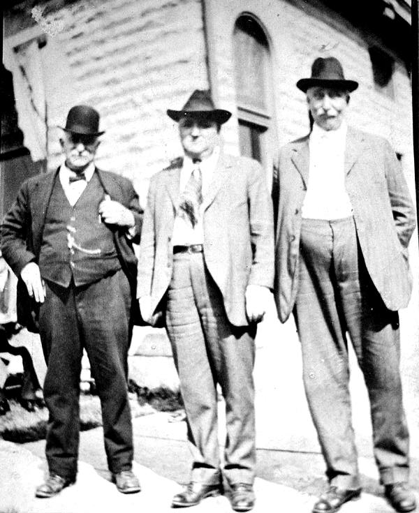 William Smith, Shorty Wible, and Lou Smith, standing behind the Smith factory office