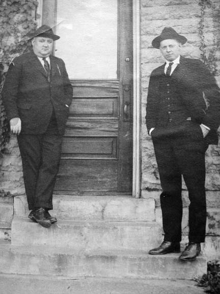 Shorty Wible and J. Swaney Hall standing on the steps of the Smith factory office
